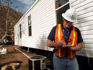 Delzura, CA., December 6, 2007-- Mark Ares, of CH2M Hill, Inc., inspects a FEMA-provided mobile home as part of the Ready for Occupancy inspection process to prepare the homes, which are one housing option used in the aftermath of disasters. The Grice family will temporarily live here as they begin to recover the loss of their home and many possessions during the October wildfires. Amanda Bicknell/FEMA